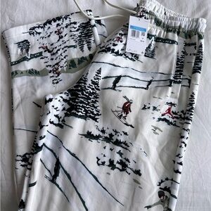 Jordan Holiday White sweats with Dark Green Black Graphic skier print Detail